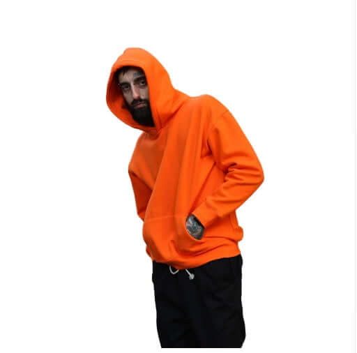 Plain multi colored hoodies worn by a model in an orange hoodie, showcasing hip hop style.